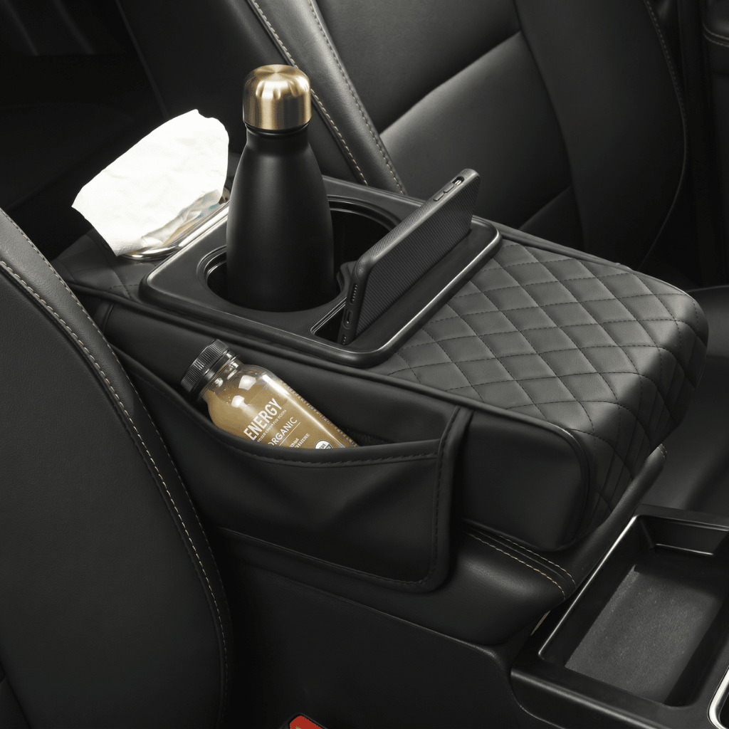 Multifunctional PU Leather Car Armrest Box Mat in vehicle with drinks and phone organized.