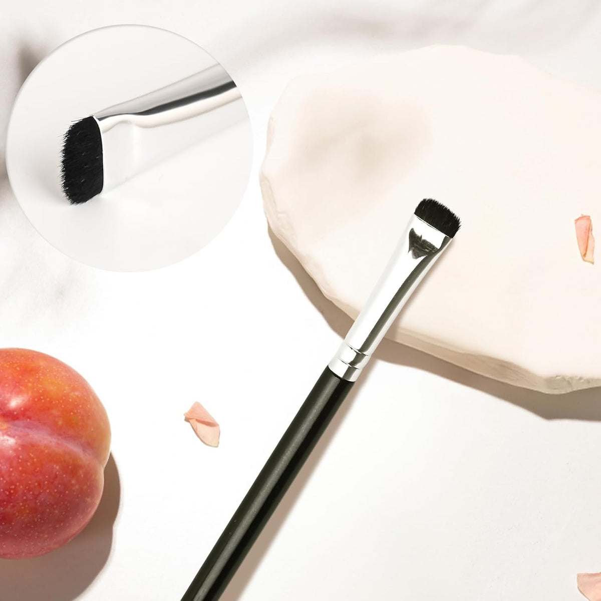 Precision Smudge Brush showcasing its precision tip for detailed eye makeup and blending on a soft surface.