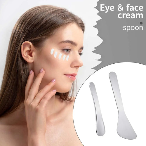 Stainless Steel Cosmetic Skincare Spatula Set with two spatulas, a woman applying cream to her face.